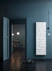 Livingston Gransasso Stone Marble radiator in Bianco White in dark blue room with dark wooden floor