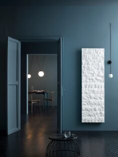 Livingston Gransasso Stone Marble radiator in Bianco White in dark blue room with dark wooden floor
