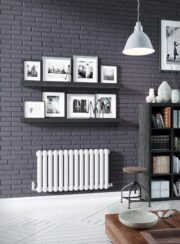 Low Max Radiator in RAL 9016 on grey wall