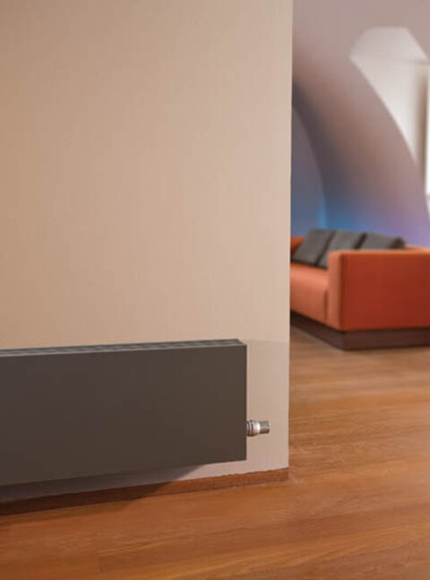 Low Jaga Strada Radiator in Sandblast Grey energy efficiency for heat pumps in living room