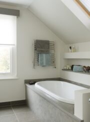 Beverley Towel Rail in Polished Stainless Steel above bath with towels