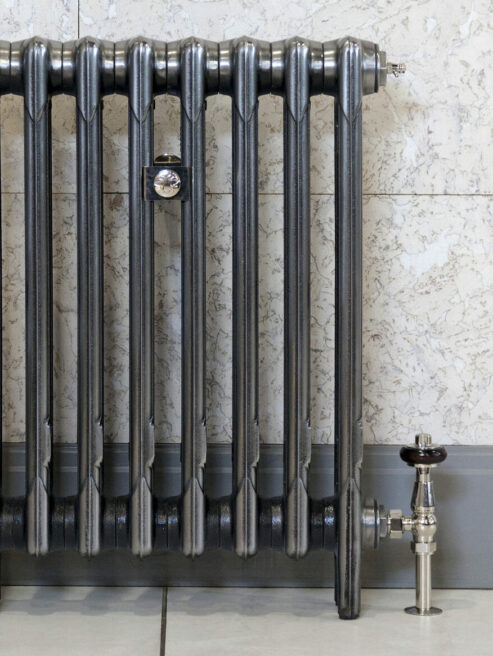 Mercury 3 Column radiator in Mirror Polish with traditional TRV valve on tiled wall