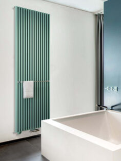 Zana Radiator in Jade Green shown in bathroom