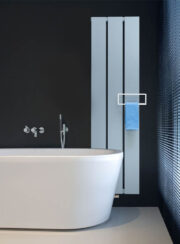 Beams aluminium radiator by Vasco with towel rail attachment shown in bathroom