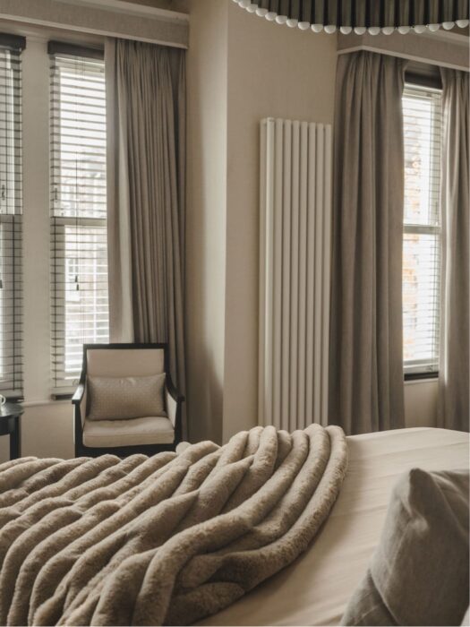 Cream Arianna Vertical radiator in bedroom