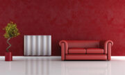 Tonda horizontal aluminium radiator Margaroli in red living room by red sofa