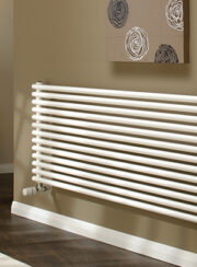 Horseshoe Round Radiator in White shown in living room
