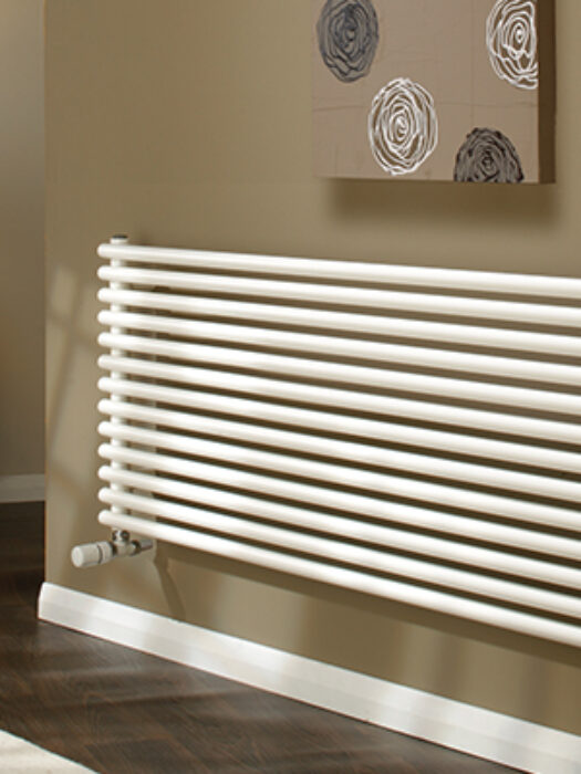 Horseshoe Round Radiator in White shown in living room