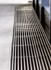 Jaga Hybird fan assisted Trench Heating with natural aluminium grille.