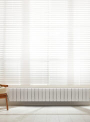 High heat output efficient Dubal Low Aluminum Radiator in white under curtains and window