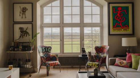 Traditional radiator under window with cat sitting on chair