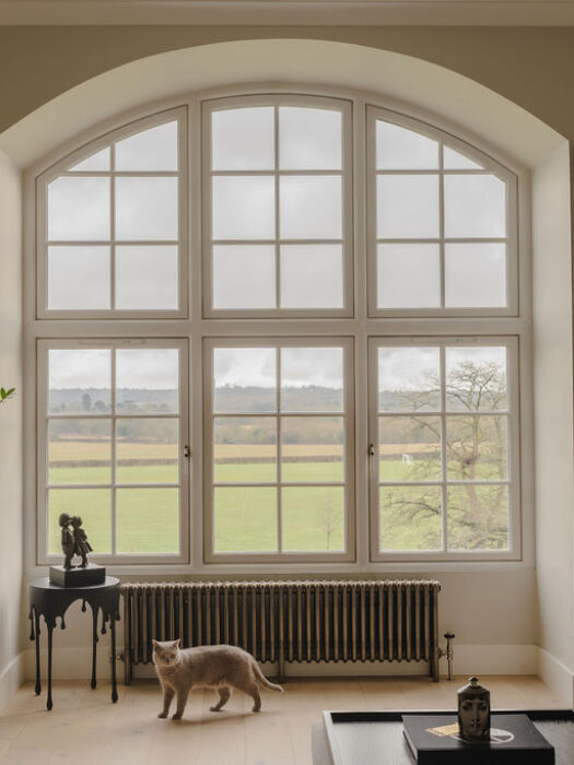 Traditional radiator in loft apartment shown under window
