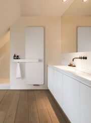Oni White Radiator with Bathroom Towel rail white sink unit and wooden floor made by Vasco