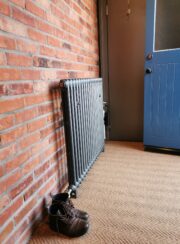 Mercury 2 Column Cast Iron radiator on brick wall dark grey colour