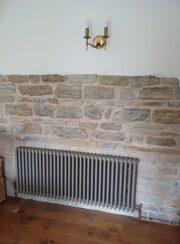Tuba Traditional Column Radiator in Balmoral Grey on bare brick wall