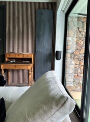 Uni Rough Painted Concrete Stone Designer Radiator from Cinier in living room by large patio door