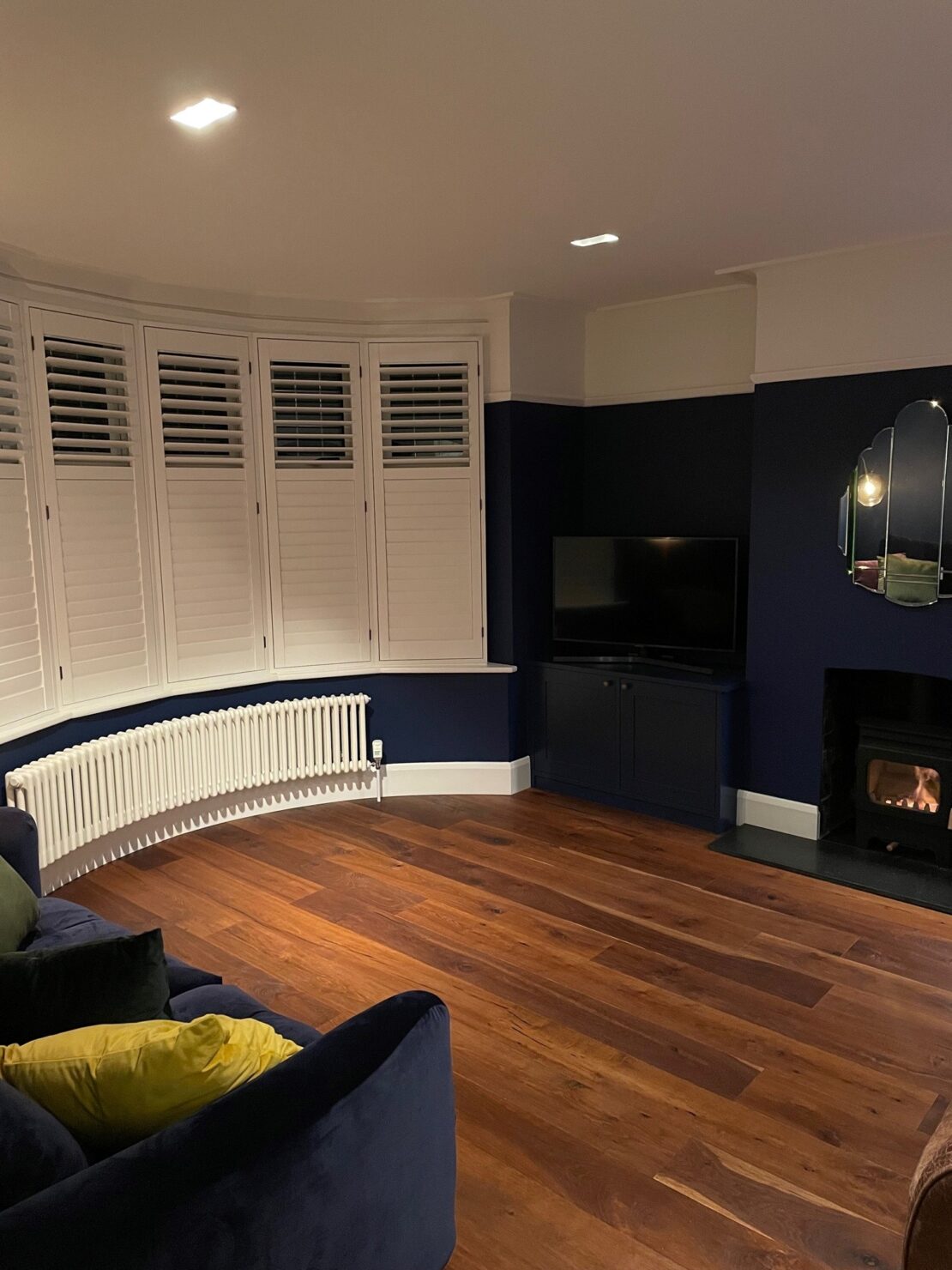 Wooden shutters dark walls and Tuba Curved Bay window steel column traditional radiator