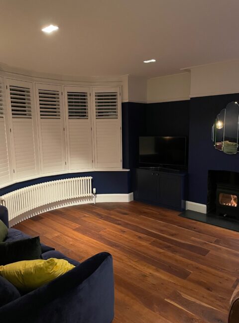 Wooden shutters dark walls and Tuba Curved Bay window steel column traditional radiator