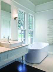 Lucy Towel Rail from Cordivari in Milky finish in white bathroom suite with wooded flooring