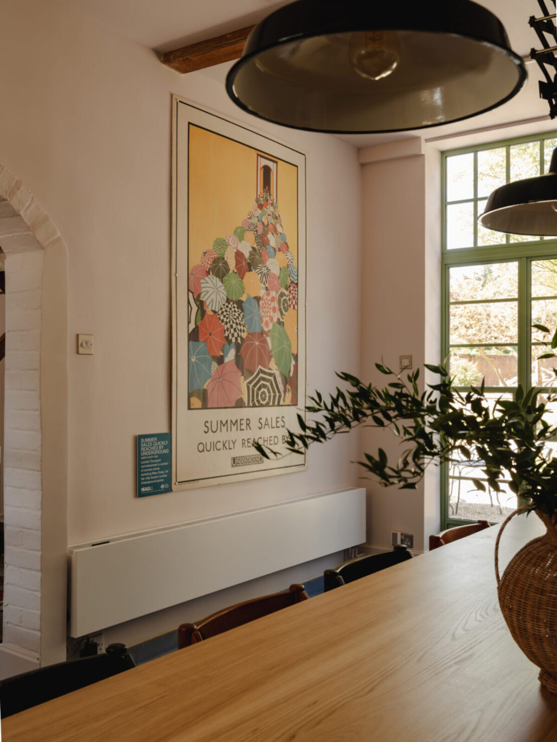 Long low white Strada Hybrid Efficiency Radiator Dining Room with large picture and wooden table