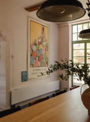 Long low white Strada Hybrid Efficiency Radiator Dining Room with large picture and wooden table