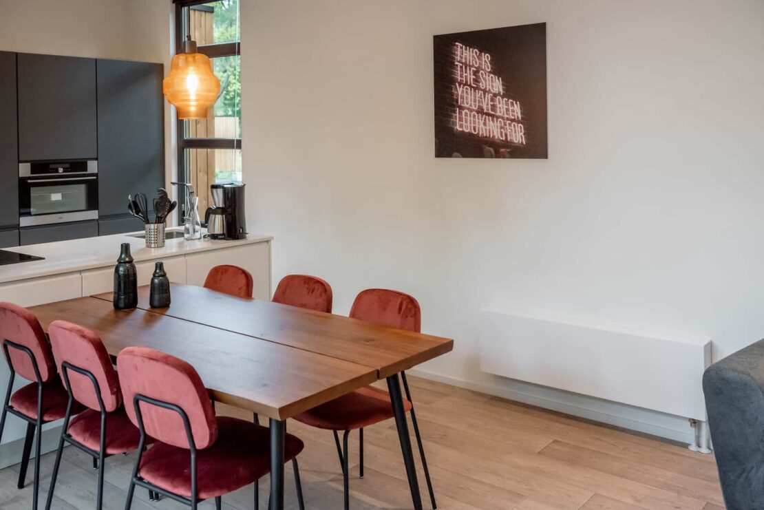 Low Jaga Strada Efficiency Radiator in white in dining room wooden floor and table