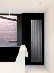 Vasco Vertical Radiator Square Tubes in white on black bathroom wall
